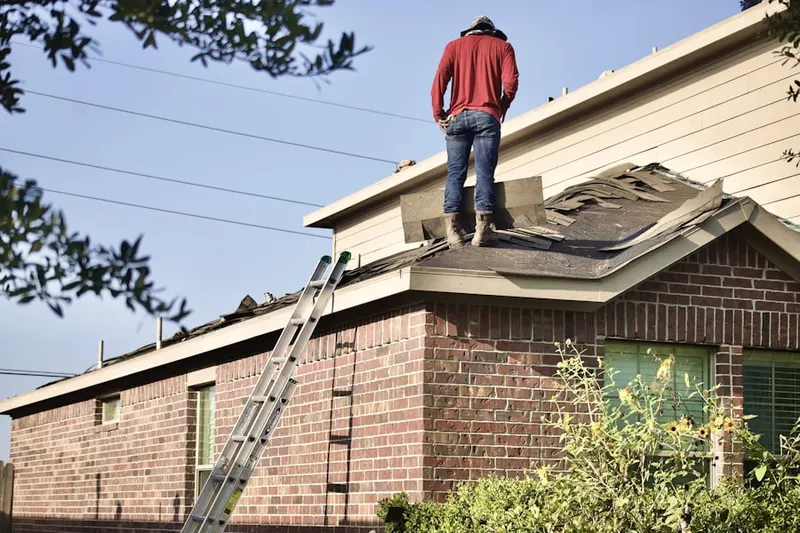 Professional roofer working on a residential roof in Bryant Park